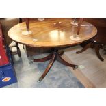 An early 19th Century mahogany tilt-top pedestal breakfast table, the cross-banded top of oval form,