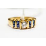 A diamond and sapphire dress ring, the central round brilliant cut diamond weighing approx 0.