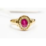 A ruby and diamond set ring, the oval cut ruby weight approx 0.