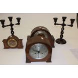 Three 1940/50's mantle clocks along with a pair of candle sticks