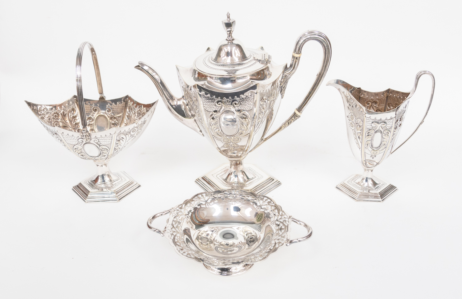 A Victorian silver plate three piece tea service, hexagonal shape chased with flowers,