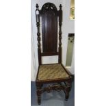 A William and Mary period or later joined oak backstool, the back with a carved crest rail,