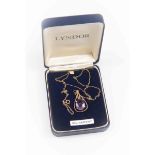 An amethyst pendant, oval stone set in a 9 ct gold open work pendant, claw set, on chain,