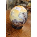 South African hand painted and lacquered Ostrich egg with original carved ring plinth