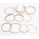 Silver bangles, ten in total, various styles including Greek key, rope, mother of pearl set,