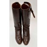 A pair of vintage brown leather riding boots,