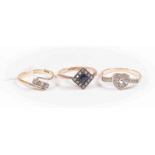 Three stone set dress rings comprising an 18ct gold and diamond cross over ring, size L,