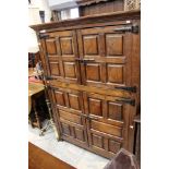 A 20th Century hand crafted joined oak hall cupboard, of two-tier form,