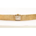 A ladies Omega 9ct gold bracelet watch with integral bark effect 9ct bracelet,