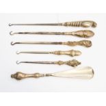 Five silver handled button hooks and a shoe horn (6)