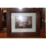 A framed copy of Victorian sepia photograph depicting seven children