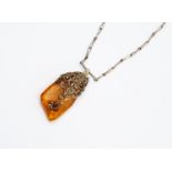 An early to mid 20th Century amber pendant necklace,