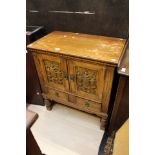 A 20th Century carved oak cabinet with one interior shelf and two small drawers at base,