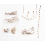 A collection of silver necklaces, bracelet, and earring sets, various designs,
