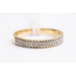 A diamond ring, comprising three rows pf pave set brilliant cut diamonds to the top,