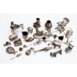 An assortment of 20th Century silver ornaments including bull dog, dachshund, washing machine, cat,