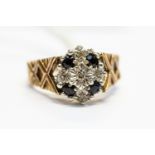 A diamond and sapphire cluster ring, set with four round cut sapphires with alternate set diamonds,