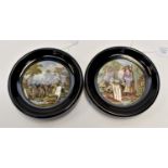 Pair of Victorian Staffordshire pot lids in ebonised frames