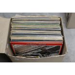 A collection of assorted records, including The Beatles, The Rolling Stones, Genesis, Fleetwood Mac,