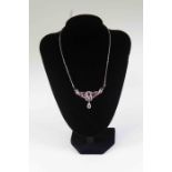 A ruby and diamond necklace, the front set with oval and round cut rubies,