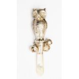 A double faced baby's rattle with mother of pearl handle,