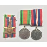 WW2 British 1939-45 Star, no ribbon, and a pair of mounted War and Defence medals.