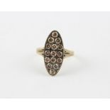 A yellow metal and cognac diamond ring, the marquise mount pave set fifteen round cut cognac