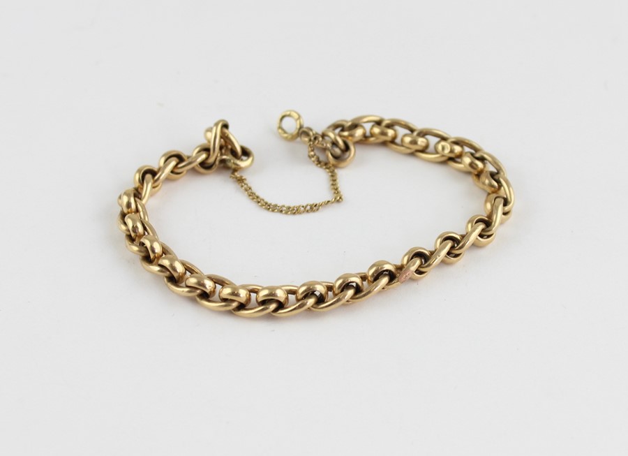 A yellow metal bracelet, formed from alternating curb and round links, (yellow metal assessed as