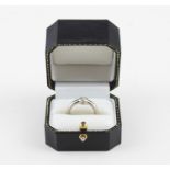 An 18ct. white gold and diamond solitaire ring, bezel set round brilliant cut diamond, (diamond