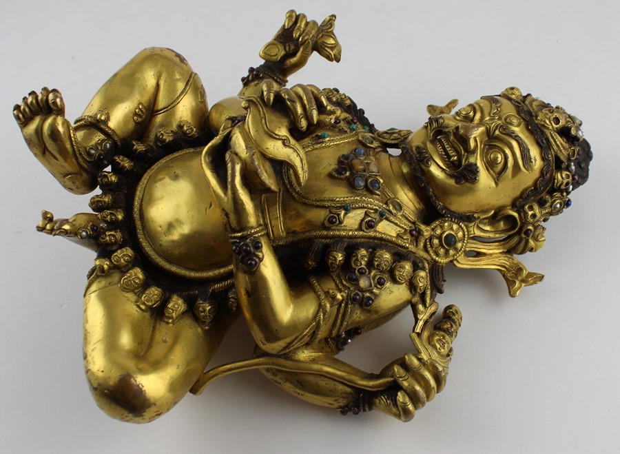 An early 20th century Sino-Tibetan gilt bronze of a seated Mahakala, the wrathful Diety having a - Image 2 of 8