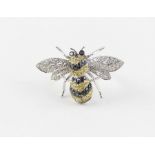 A 14ct. white gold and diamond ring fashioned as a bumble bee, the fore and hind wings set round cut