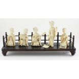 A japanese Ivory Meiji period set of seated musicians raised on original ebonised base