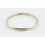 A 9ct. yellow gold bangle, of circular form, assayed London 1978, width 6mm x diameter 70mm. (24.