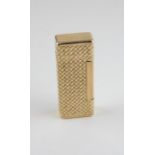 A French 18ct. yellow gold petrol lighter, having geometric basket weave pattern to sides with plain