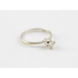 An 18ct. white gold and diamond solitaire ring, four claw set round brilliant cut diamond, (