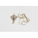 An Art Nouveau 9ct. rose gold, peridot and seed pearl pendant, of inverted openwork pear shaped form
