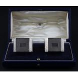 A pair of silver napkins, by Mappin & Webb Ltd, assayed Birmingham 1939, of square form with