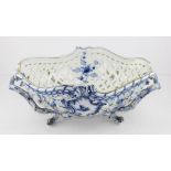 An early 20th century Berlin porcelain twin handled basket, of shaped oval outline decorated with