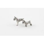 Two sterling silver miniature dogs; a small schnauzer and a larger stylised hound, with import marks