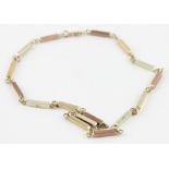 A 9ct. tri-coloured gold chain, formed from rectangular bar links of rose, yellow and white gold,