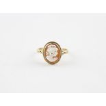A 9ct. gold cameo ring, set oval carved shell cameo of a profile bust of a lady looking right, shank