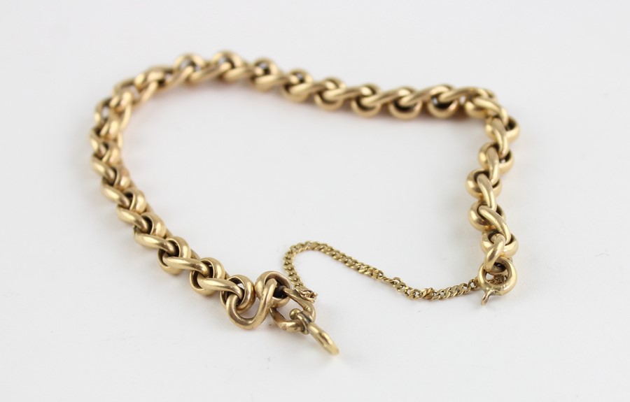 A yellow metal bracelet, formed from alternating curb and round links, (yellow metal assessed as - Image 2 of 2