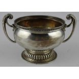 A silver twin handled circular pedestal bowl, by Goldsmiths & Silversmiths Co Ltd, assayed London