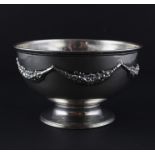 A silver circular bowl, assayed Birmingham 1904, makers mark rubbed, the side decorated with applied