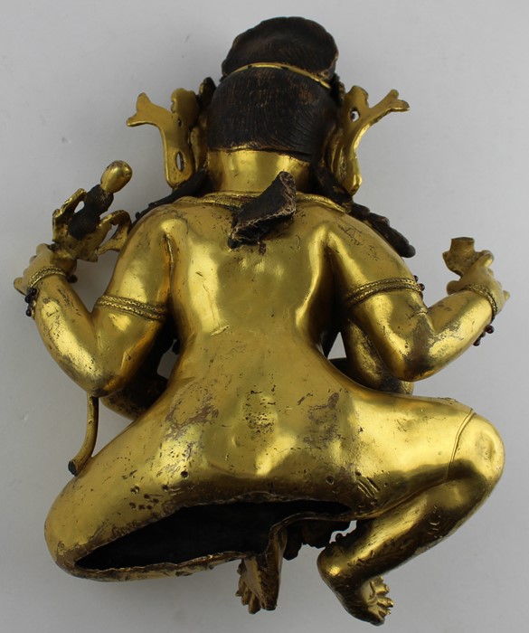 An early 20th century Sino-Tibetan gilt bronze of a seated Mahakala, the wrathful Diety having a - Image 4 of 8