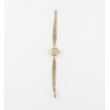 An 18ct. yellow gold Omega Ladymatic ladies' bracelet watch, manual wind, having circular enamel