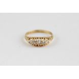 An 18ct. gold and five stone diamond ring, having gently arched and pierced mount set five graduated