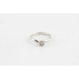 An 18ct. white gold and diamond cross-over style ring, the mount illusion set with single round