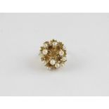 A 14ct. yellow gold and pearl dress ring. c.1970's, the large openwork mount fashioned as highly