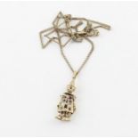 A 9ct. yellow gold "clown" pendent, the articulated figure wearing jacket pierced with hearts to